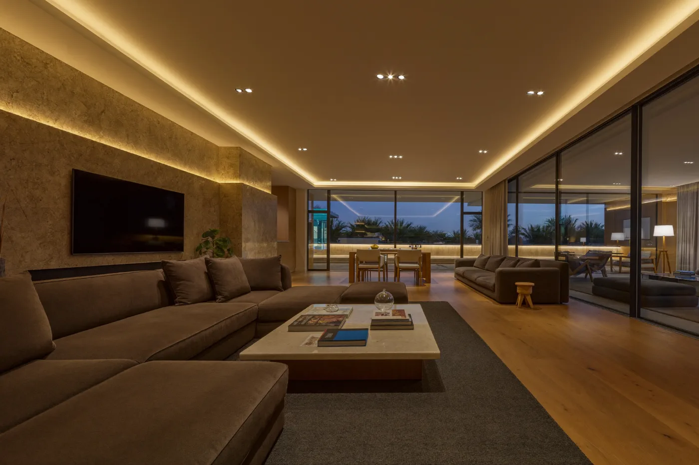 Villa living room lit by newly installed recessed and cove lighting