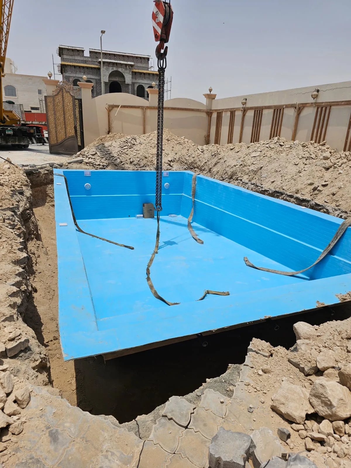 Fiberglass pool shell set into its excavation at a villa site