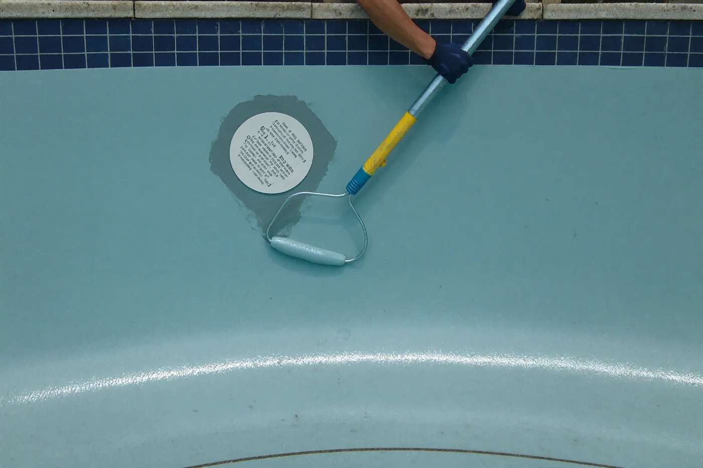 Gelcoat resin being applied to repair a fiberglass pool shell